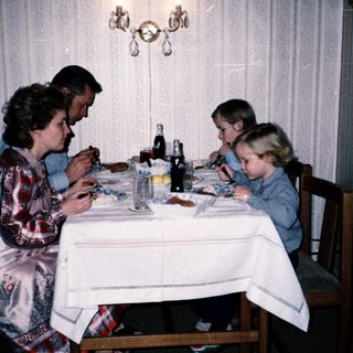 Family dining together indoors at a table.