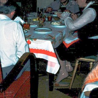 Family gathering around festive table indoors.