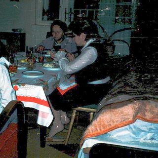 Family gathering around festive table indoors.
