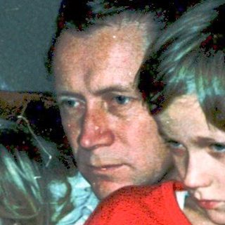 Family watching television indoors, mid-1970s.