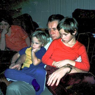 Family watching television indoors, mid-1970s.