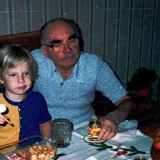 Family enjoying meal together indoors with cake.