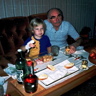Family enjoying meal together indoors with cake.
