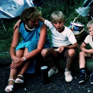 Family camping outdoors under a tent.