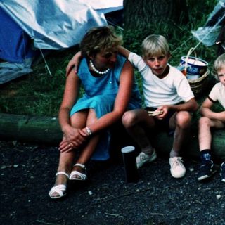 Family camping outdoors under a tent.