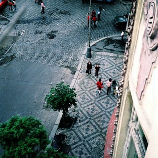 Urban street scene with cobblestone pedestrian path.
