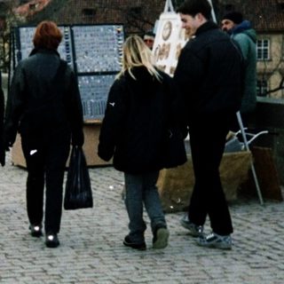 People walking on Prague's Charles Bridge.