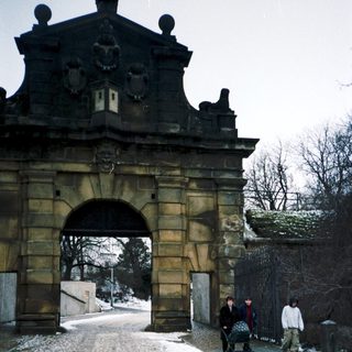 Historic stone archway entrance with winter snow.