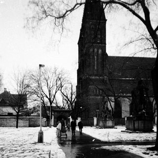 Winter street scene near historic church.