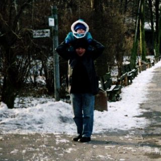 Person walking alone on snow-covered path.