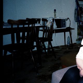 A woman holding a baby indoors.