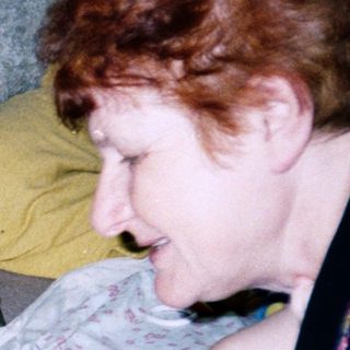 Woman breastfeeding baby on a couch.