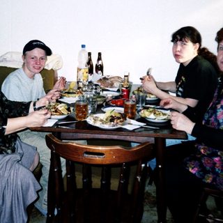 Family gathering enjoying meal indoors together.