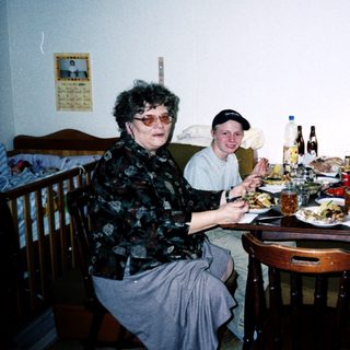 Family gathering enjoying meal indoors together.