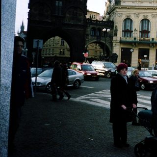 Urban street scene with historic building and pedestrians.