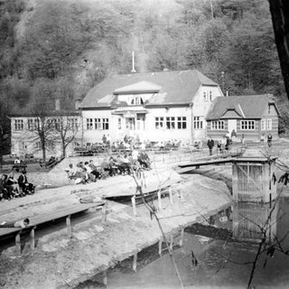 Historic lakeside resort with outdoor seating.