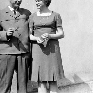 Couple posing together outdoors in vintage clothing.