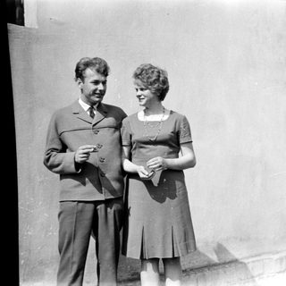 Couple posing together outdoors in vintage clothing.