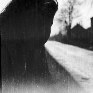 Silhouette of person looking out in rain.