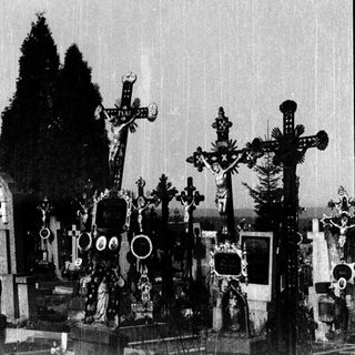 Elaborate cemetery crosses and tombs in grayscale.
