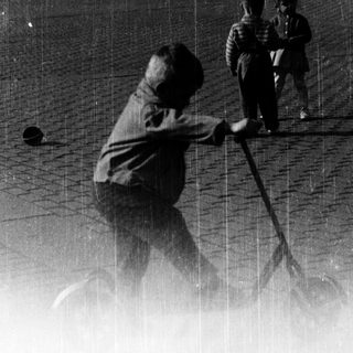 Children playing with baseball bats in rain.