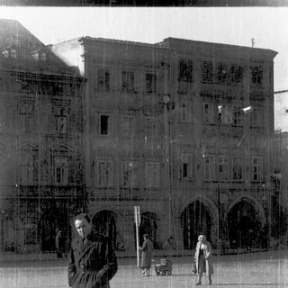Reflection of historic building facade in wet ground.
