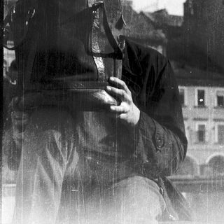 Man in gas mask holding gas canister.