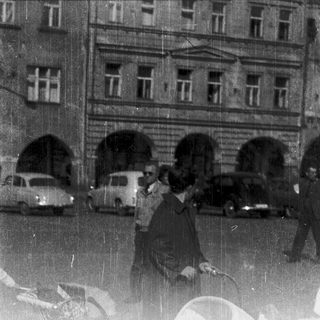 People walking in rain on city street.