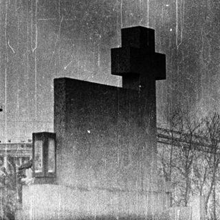 Industrial facility with tall smokestacks and buildings.