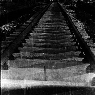 Railroad tracks with concrete steps leading upward.