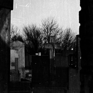 Rainy cityscape viewed through a window.