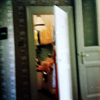 Blurred reflection of person in doorway.