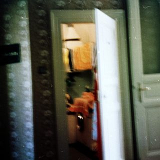 Blurred reflection of person in doorway.