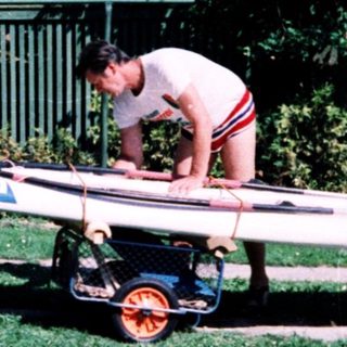 Family preparing surfboard for beach outing.