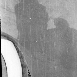 Silhouette of person playing guitar.