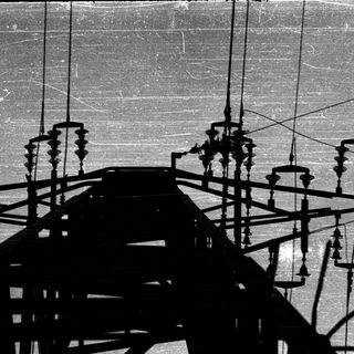 Shadow of ornate metal structure on wall.