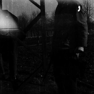 Blurred industrial scene with silhouetted trees.