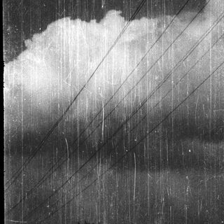 Heavy rain falling through dark storm clouds.