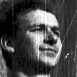 Young man posing confidently on balcony railing.