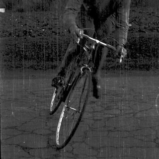 Man riding bicycle in outdoor setting.