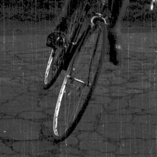 Man riding bicycle in outdoor setting.