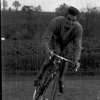 Man riding bicycle in outdoor setting.