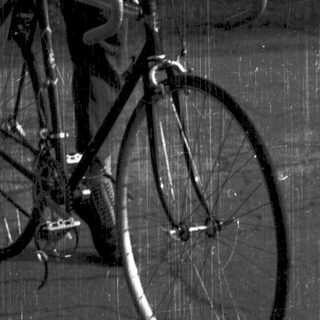 Man riding vintage road bicycle outdoors.