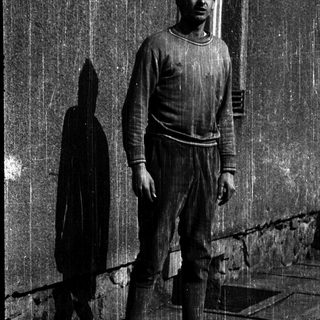 Statue of man with tall vertical spikes.