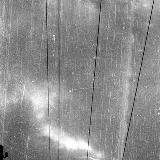 Rusty metal surface with visible cracks and power lines.