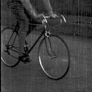 Man riding road bicycle outdoors.