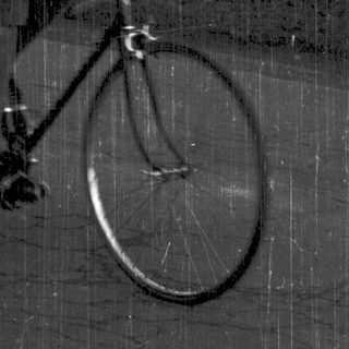 Man riding road bicycle outdoors.