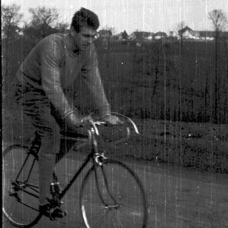 Man riding road bicycle outdoors.