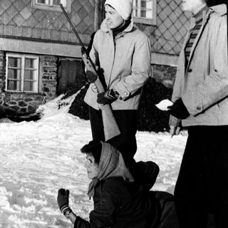 People playing snow games with ski poles.