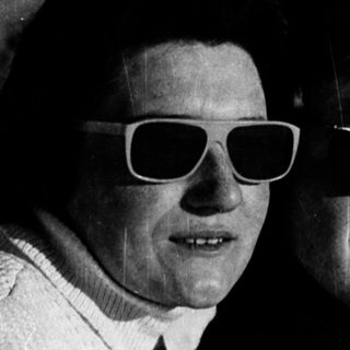 Two women wearing sunglasses and casual attire outdoors.
